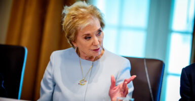Secretary of Education Linda McMahon, in a light blue suit, makes a point during a White House Cabinet meeting.