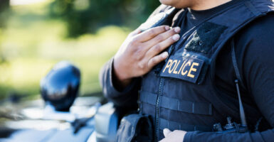 A police officer holds his right hand over his heart