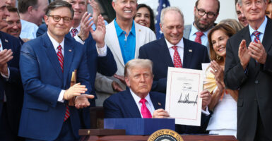 With congressional backers looking on, President Donald Trump signs the One, Big Beautiful Bill into law on July 4.