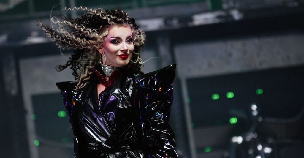 The drag performer Bosco wearing black leather dress and a Bride of Frankenstein hairdo.
