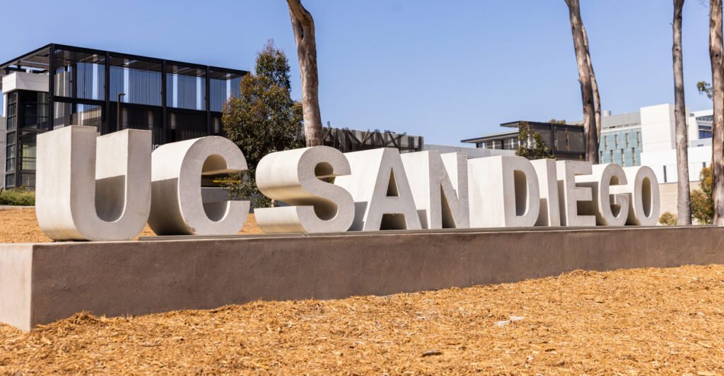 A "UC San Diego" sign outside campus.