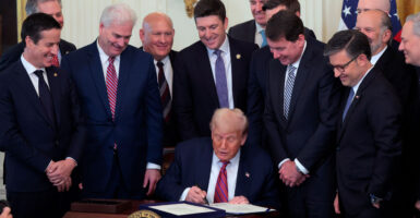 Surrounded by Republican lawmakers, President Donald Trump signs legislation Friday at the White House.