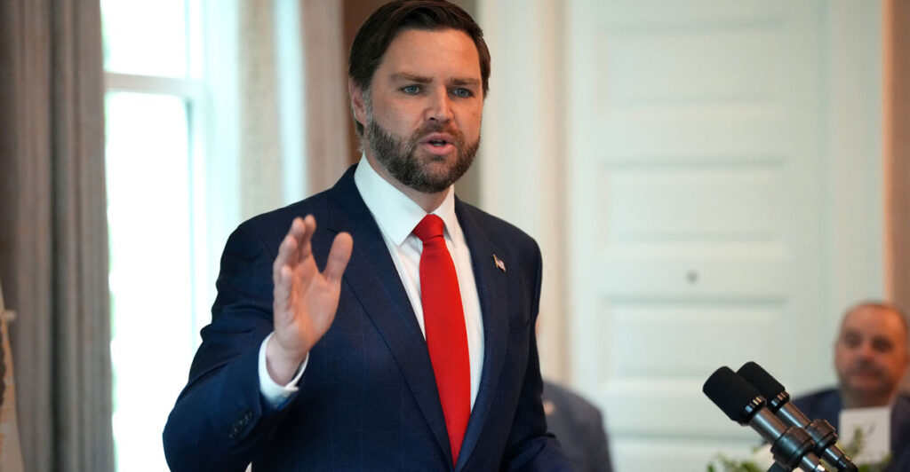 Vice President JD Vance, wearing a white shirt with a red tie.