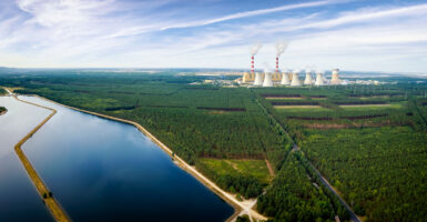 A Polish powerplant in the distance, with a waterway along the left side of the image.