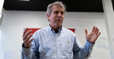 Then-Sen, Sherrod Brown in a blue shirt speaks with hands wide.