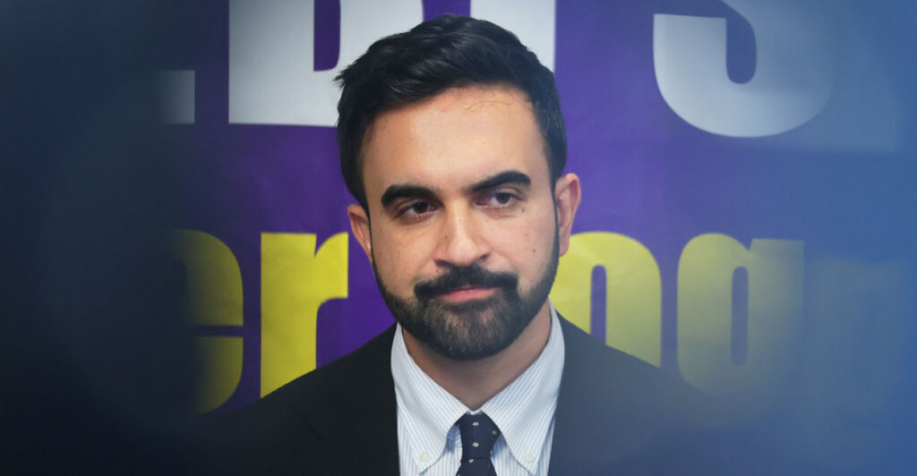 A close-up of a grimacing Zohran Mamdani, with the edges of the frame out of focus.