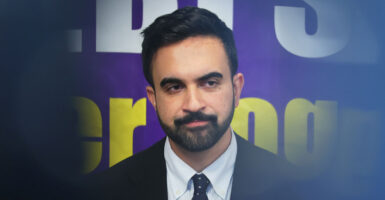 A close-up of a grimacing Zohran Mamdani, with the edges of the frame out of focus.