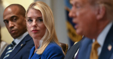 Secretary of Housing and Urban Development Scott Turner and Attorney General Pam Bondi look on as President Donald Trump speaks during a cabinet meeting