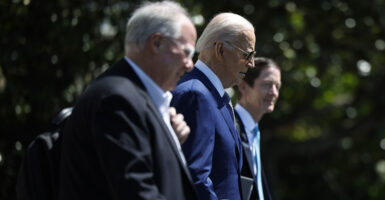 Then-President Joe Biden is flanked by senior adviser Mike Donilon (left) and Deputy Chief of Staff Bruce Reed.