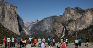 Visitors take in the scenery from Tunnel View in Yosemite National Park.