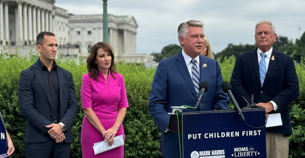 From left, education activist Corey DeAngelis; Tina Descovich, CEO and co-founder of Moms for Liberty; and Reps. Mary Miller, R-Ill. (obscured), and Ralph Norman, R-S.C., look on as Rep. Mark Harris, R-N.C., speaks at a press conference outside the Capitol on Wednesday.