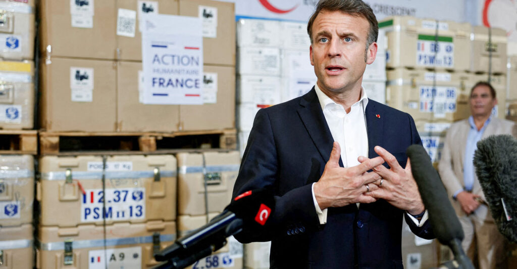 French President Emmanuel Macron talks to reporters during a visit at Egyptian Red Crescent warehouses storing aid for Gaza in the Egyptian border town of El-Arish, Egypt, on April 8.