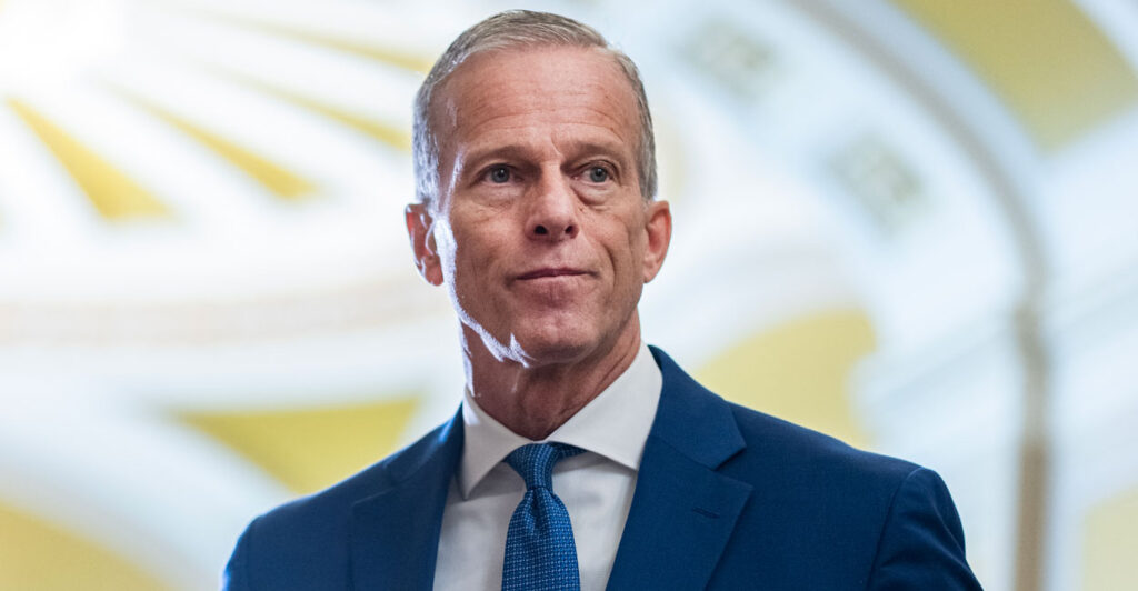 John Thune stands in the Capitol facing onward.