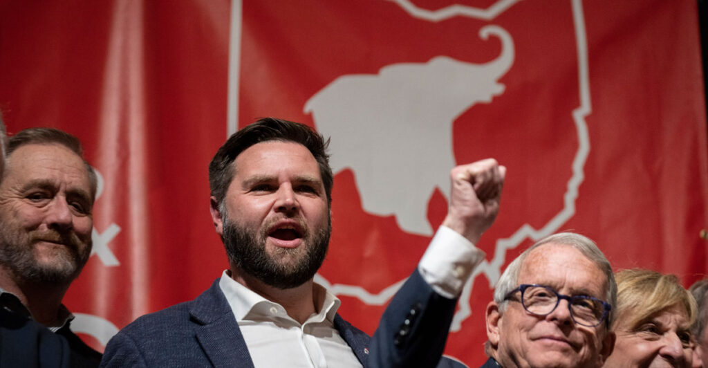 JD Vance and Mike DeWine raise a fist in the air.