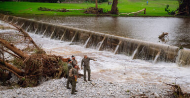 A K-9 unit with the Texas Game Wardens conducts a search amid flood damage near Camp Mystic in Kerr County, Texas on Saturday.