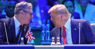 President Donald Trump and UK Prime Minister lean in to talk at the 2025 NATO Summit.