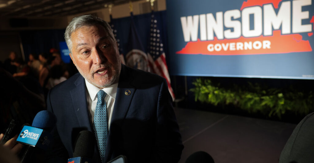 Virginia Republican lieutenant governor nominee John Reid at a rally with a winsome for governor sign in the background