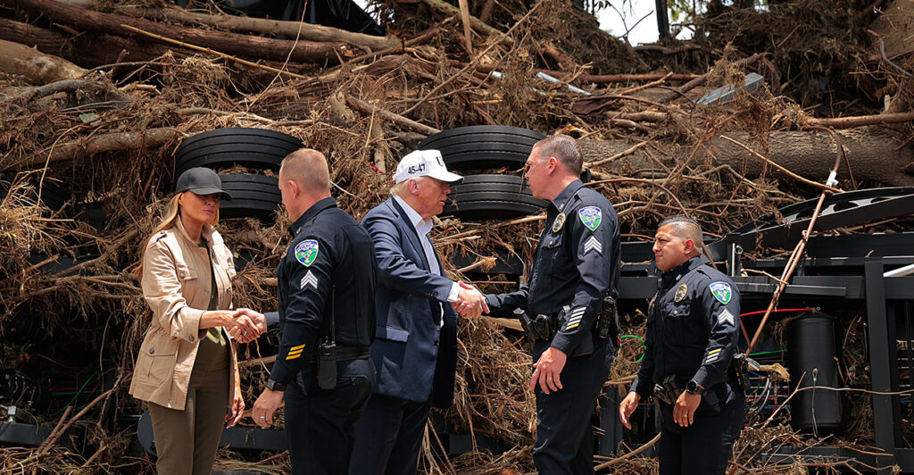 President Donald Trump and first lady Melania Trump meet with emergency services personnel in flood-ravaged Kerrville, Texas, on Friday.