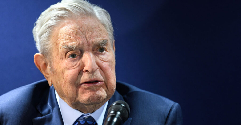 Leftist billionaire George Soros speaking into a microphone