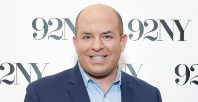 CNN's Brian Stelter, seen here on Nov. 14, 2023, in New York City with a backdrop that says "92NY"
