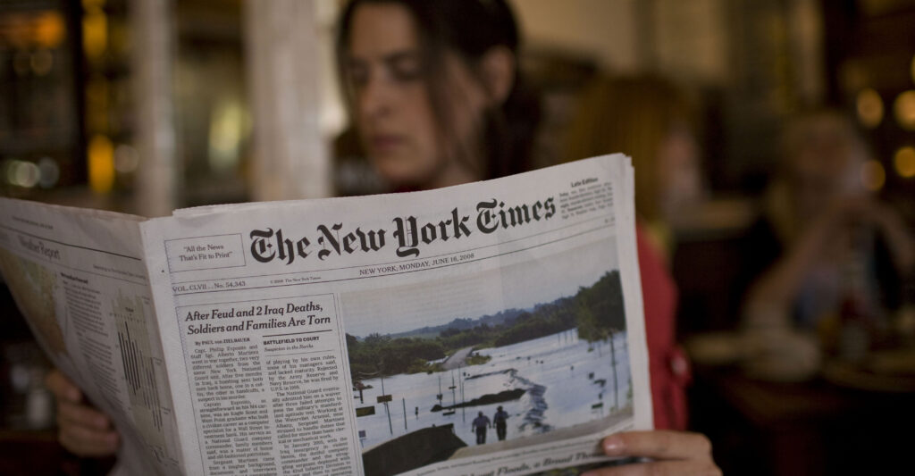 A woman reads The New York Times