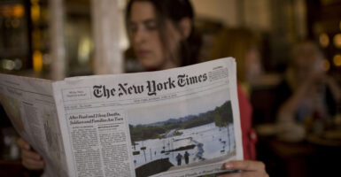 A woman reads The New York Times