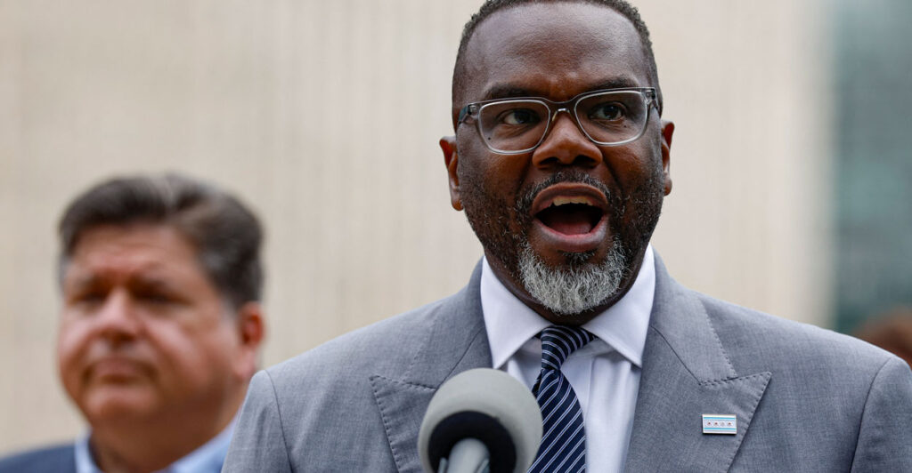 Chicago Mayor Brandon Johnson speaks at a press conference Monday as Illinois Gov. JB Pritzker looks on. Both Democrats strongly rejected any move by President Donald Trump to send National Guard troops to Chicago to fight crime.