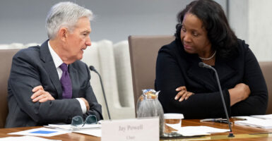 Federal Reserve Chairman Jerome Powell and Fed Governor Lisa Cook confer in a meeting at the Federal Reserve Board building in Washington, D.C., on June 25.