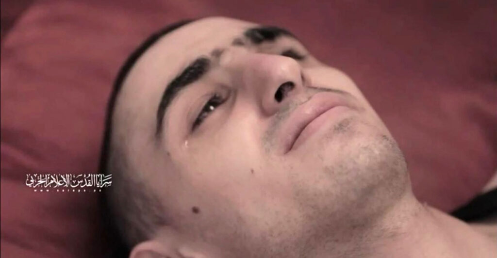 Close-up of Israeli Rom Braslavksi, who is being held hostage by Hamas, laying down.