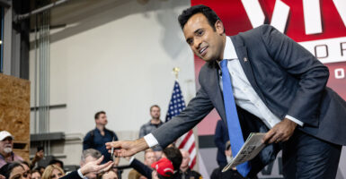 Ramaswamy greets supporters and signs books on stage.