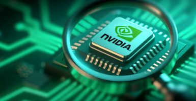 A Nvidia chip is seen through a magnifying glass amid green lighting.