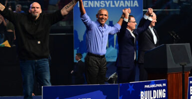 From left, John Fetterman, former President Barack Obama, Josh Shapiro, and then-President Joe Biden join hands upon preparing to depart a Democrat campaign rally on Nov. 5, 2022, in Philadelphia.