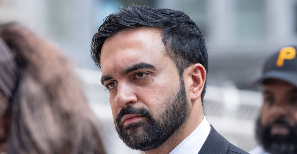 Close-up of stern-looking Zohran Mamdani.