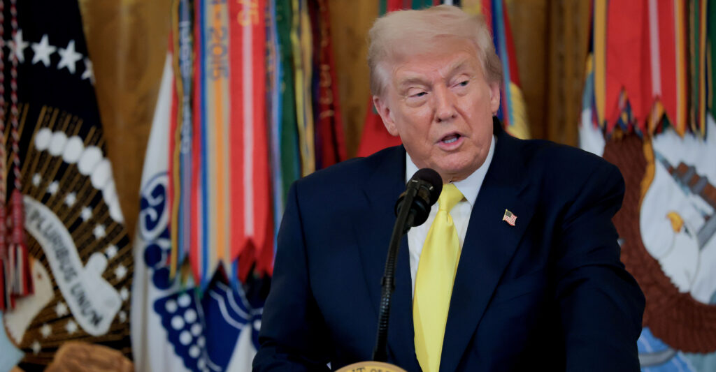 Donald Trump speaking at a podium