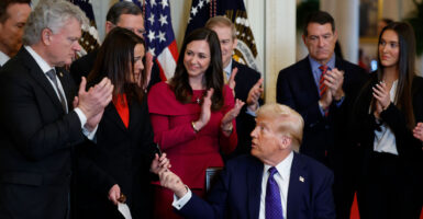 President Donald Trump hands a pen to Laken Riley's mother, Allyson, after using it to sign the Laken Riley Act into law on Jan. 29. (Chip Somodevilla/Getty Images)