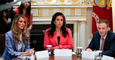 Tulsi Gabbard, flanked on her left by Lee Zeldin, and on her right by Kelly Loeffler, listens in during a White House Cabinet meeting.