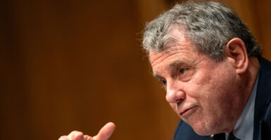 Former Sen. Sherrod Brown gestures as he speaks during a committee hearing.