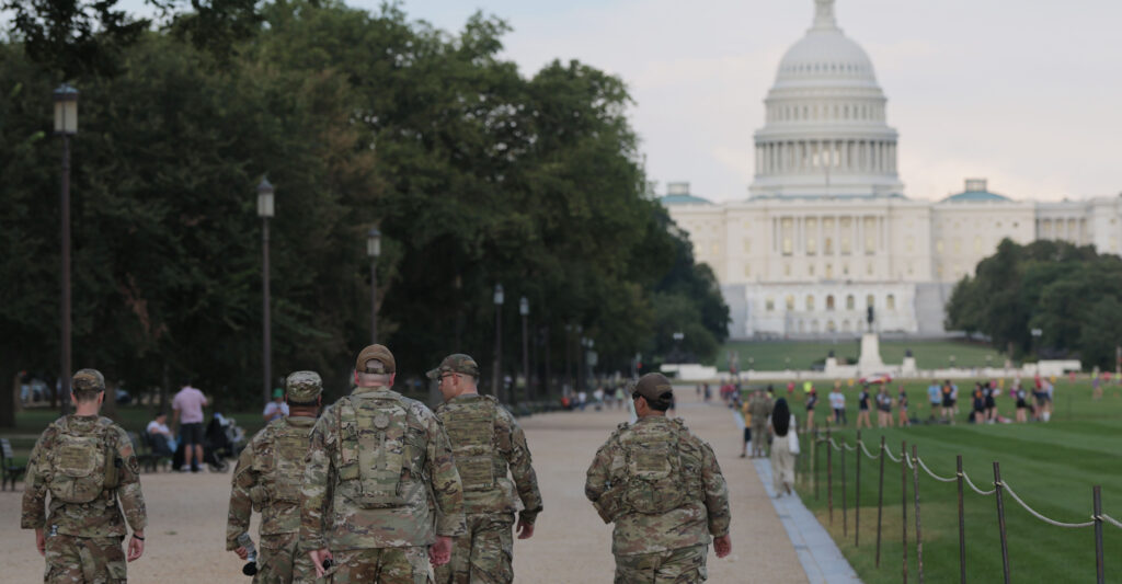 Members of the National Guard walk on the National Mall on August 14, 2025.
