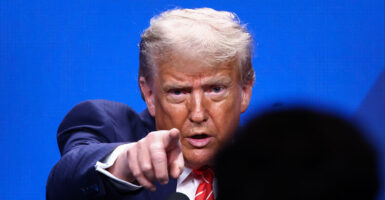 President Donald Trump in a blue suit points