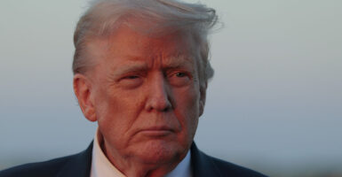 Donald Trump in a suit looks into the distance