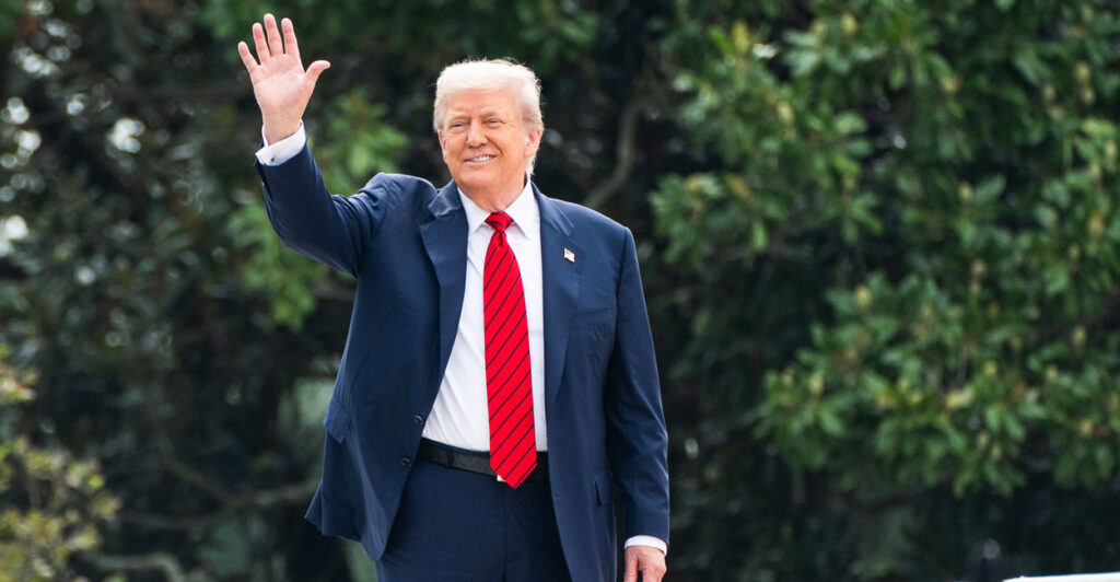 Trump waves to reporters from the White House roof