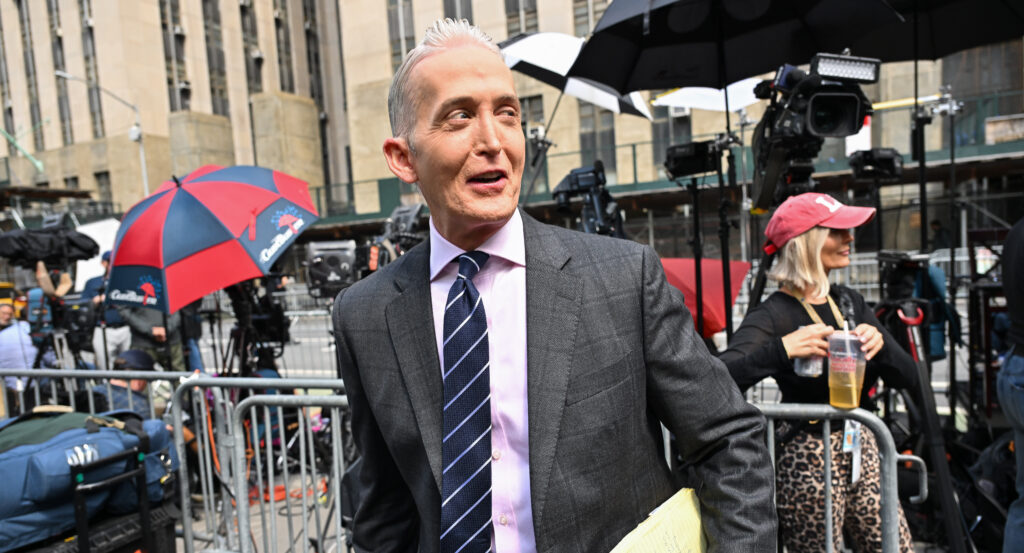 Trey Gowdy walks outside Manhattan Criminal Courthouse holding some documents.