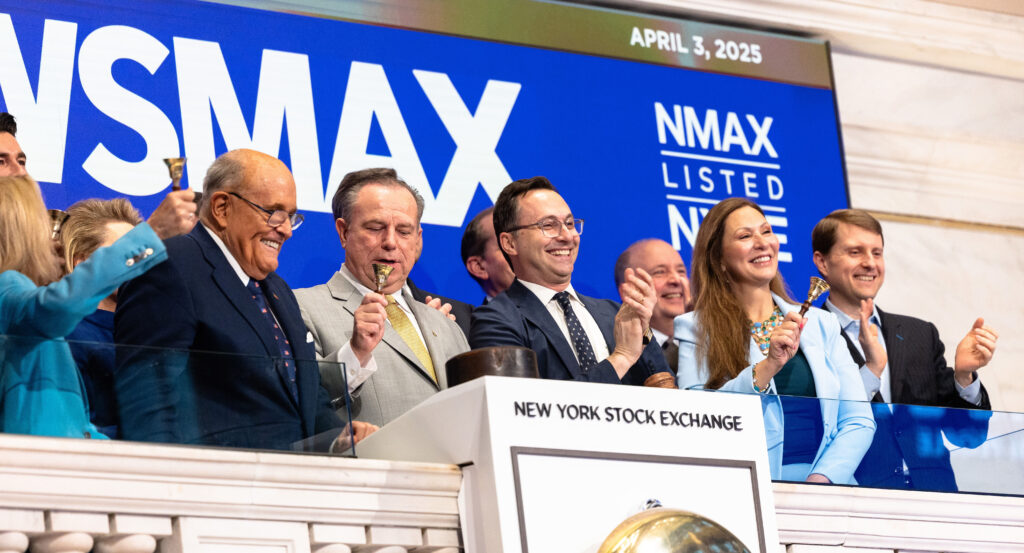 Chris Ruddy and Rudy Juliani are celebrating at the New York Stock Exchange.