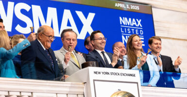 Chris Ruddy and Rudy Juliani are celebrating at the New York Stock Exchange.