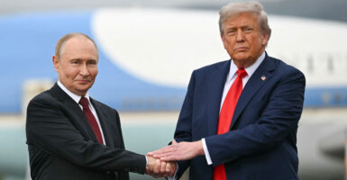 U.S. President Donald Trump greets Russian President Vladimir Putin.