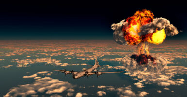 The Enola Gay B-29 Superfortress flying away from the giant mushroom cloud created by the explosion of the atomic bomb dropped over the Japanese city of Hiroshima during World War II.