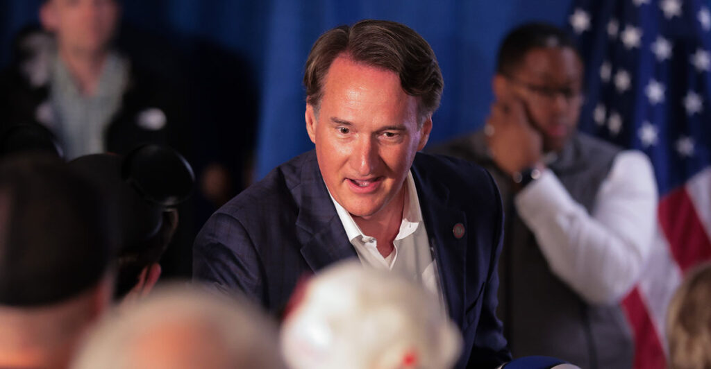 Glenn Youngkin shakes someone's hand at a Winsome Earle-Sears rally.
