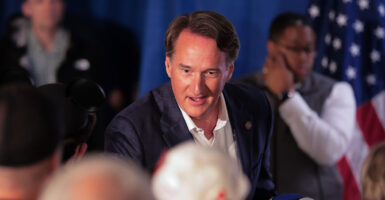Glenn Youngkin shakes someone's hand at a Winsome Earle-Sears rally.