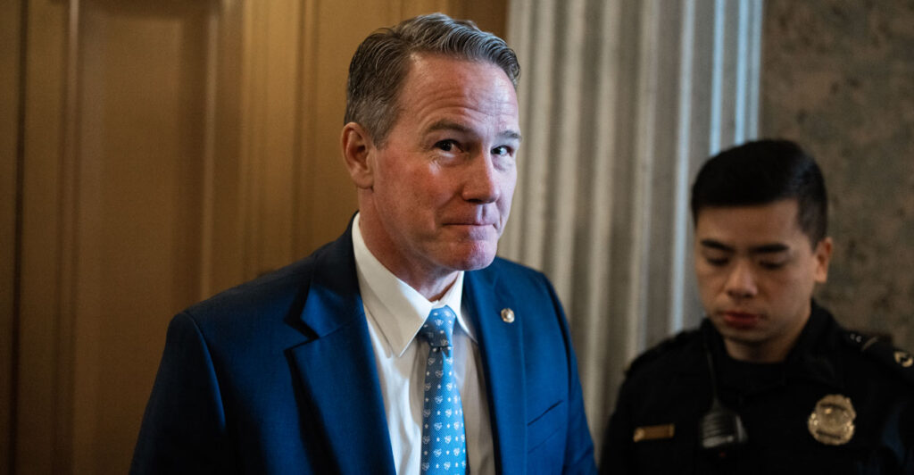 Sen. Jon Husted smirks at the camera while coming out of a building on Capitol Hill.