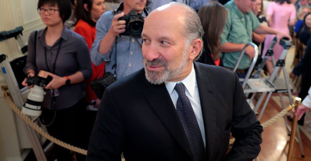 Commerce Secretary Howard Lutnick looks to the side.